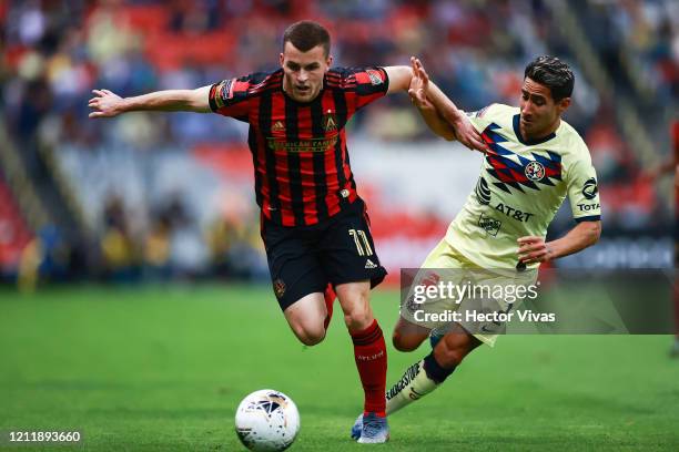 Brooks Lennon of Atlanta United struggles for the ball against Luis Fuentes of America during a quarter final first leg match between Club America...