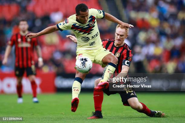 Giovani Dos Santos of America struggles for the ball against Jeff Larentowicz of Atlanta United during a quarter final first leg match between Club...