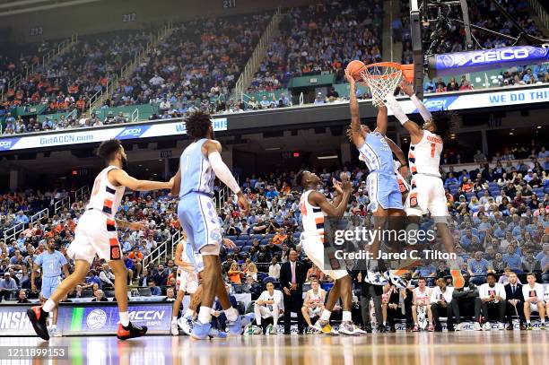 Armando Bacot of the North Carolina Tar Heels attempts a shot against Quincy Guerrier of the Syracuse Orange during their game in the second round of...