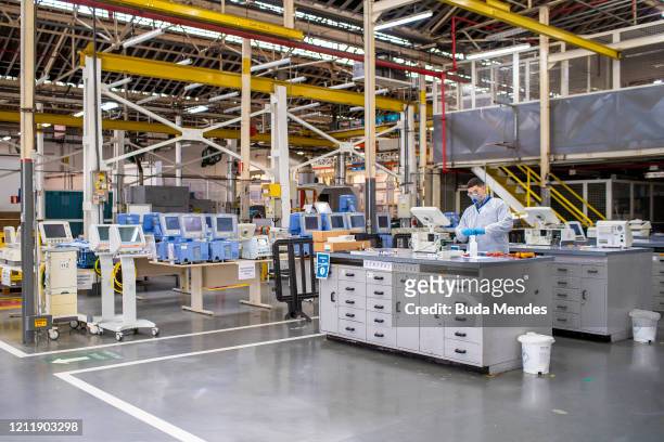Technician of the General Motors factory repairs a ventilator from a public hospital amidst the COVID-19 pandemic on May 4, 2020 in Sao Caetano do...