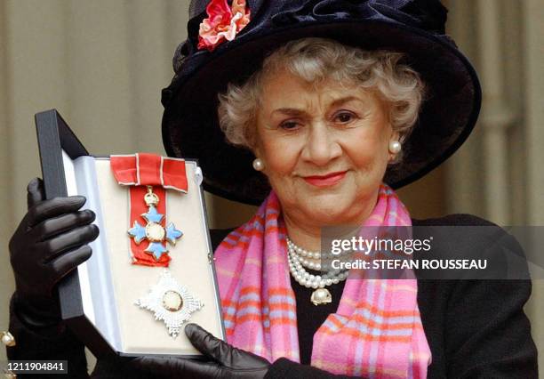 Actress Joan Plowright poses for pictires after being made a Dame by the Prince Of Wales at Buckingham Palace in London, 20 February, 2004. Dame...