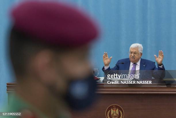 Palestinian President Mahmoud Abbas delivers a speech during the Palestinian leadership meeting at the headquarters, in the West Bank city of...