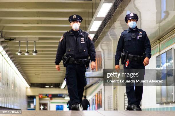 Officers patrol inside Times Square station as the New York City subway system, the largest public transportation system in the nation is set for...