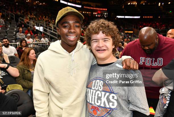 Caleb McLaughlin and Gaten Matarazzo attend New York Knicks vs Atlanta Hawks game at State Farm Arena on March 11, 2020 in Atlanta, Georgia.