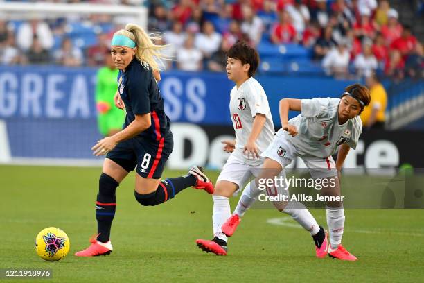 Julie Ertz of the United States moves the ball against Emi Nakajima of Japan and Yuka Momoki during the first half of the SheBelieves Cup match at...