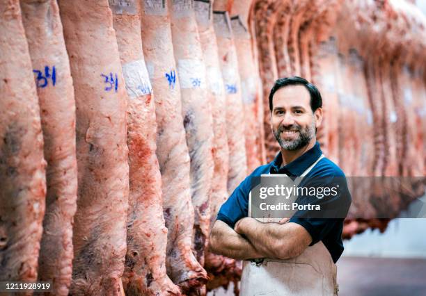 confident male butcher at slaughterhouse - meat packing stock pictures, royalty-free photos & images