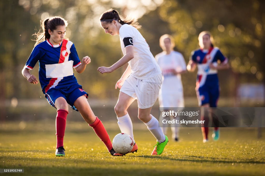 Determined Teenage Girls Playing Soccer Match On A Stadium High Res determined-teenage-girls-playing-soccer-match-on-a-stadium-high-res