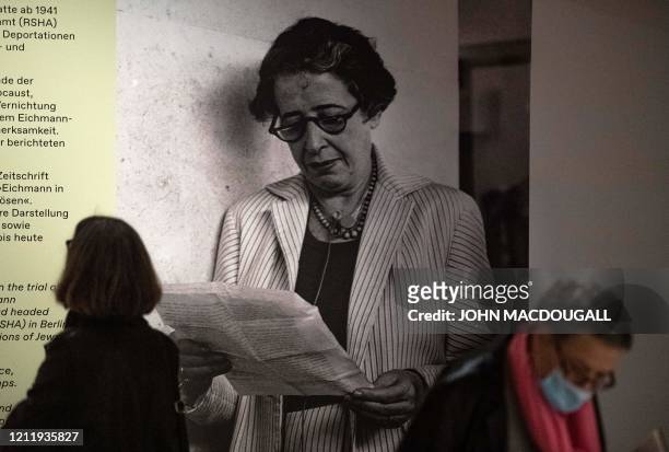 Visitor stands next to a photograph of German-American philosopher and political theorist Hannah Arendt during a press preview of the exhibition...