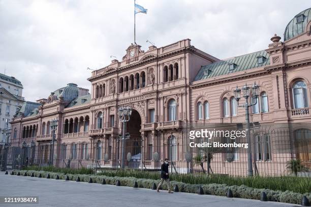 Pedestrian wearing a protective mask walks in front of the Casa Rosada in Buenos Aires, Argentina, on Tuesday, May 5, 2020. Argentina's nationwide...