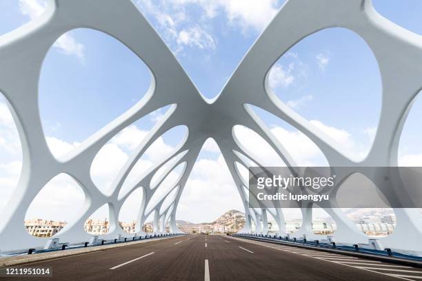 empty road with modern bridge - qingdao bridge stock pictures, royalty-free photos & images