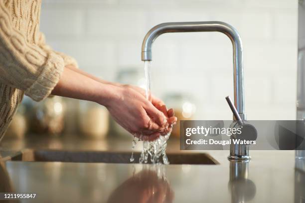 washing hands in kitchen sink. - fregadero fotografías e imágenes de stock