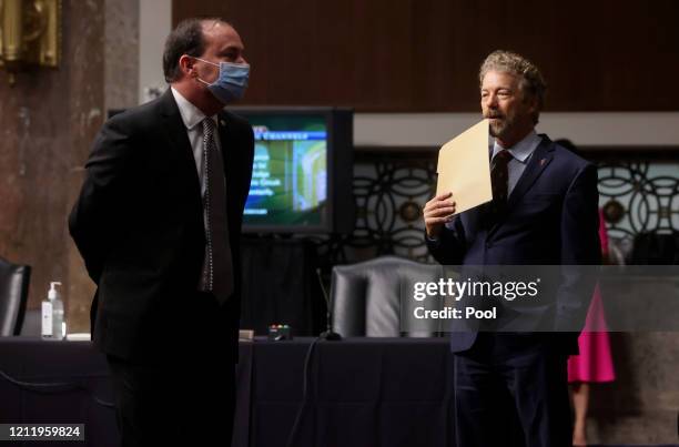 Sen. Mike Lee wears a protective face mask because of the COVID-19 outbreak as he talks with U.S. Sen. Rand Paul before the start of Judge Justin...