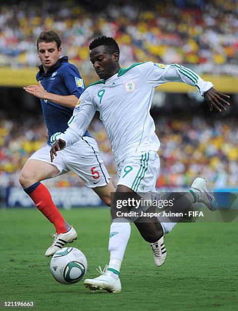Olarenwaju Kayode of Nigeria duels for the ball with Sebastien Faure of France during the FIFA U-20 World Cup Colombia 2011 quarter final match...