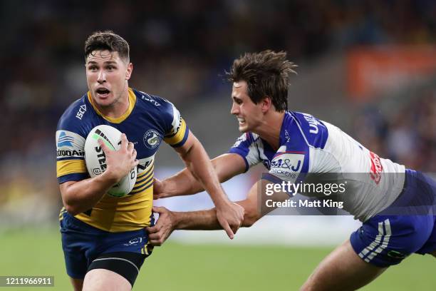 Mitchell Moses of the Eels gets past Lachlan Lewis of the Bulldogs during the round 1 NRL match between the Parramatta Eels and the Canterbury...