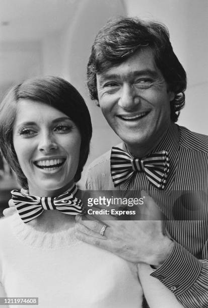 Canadian-American actress Beverly Adams and her husband, British-American hairstylist Vidal Sassoon , both smiling and wearing matching striped bow...