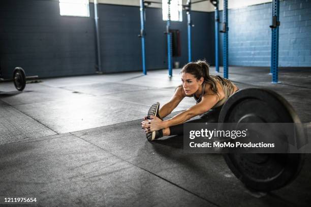 woman stretching after cross training class - complete body stock pictures, royalty-free photos & images