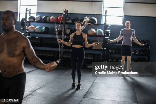 woman jumping rope in cross training class - skipping along stock pictures, royalty-free photos & images