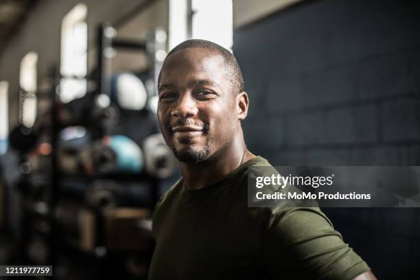 portrait of man in cross training gym - exercise motivation stock pictures, royalty-free photos & images