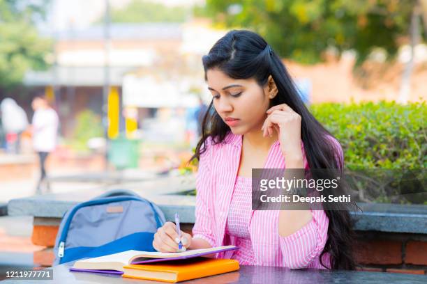 student sitting on campus stock photo - test preparation stock pictures, royalty-free photos & images