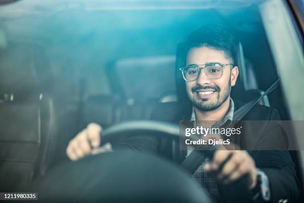 middle eastern businessman driving a car. - monacle glasses stock pictures, royalty-free photos & images