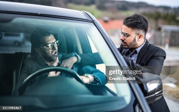 two drivers starting a fight on the road. - road rage stock pictures, royalty-free photos & images