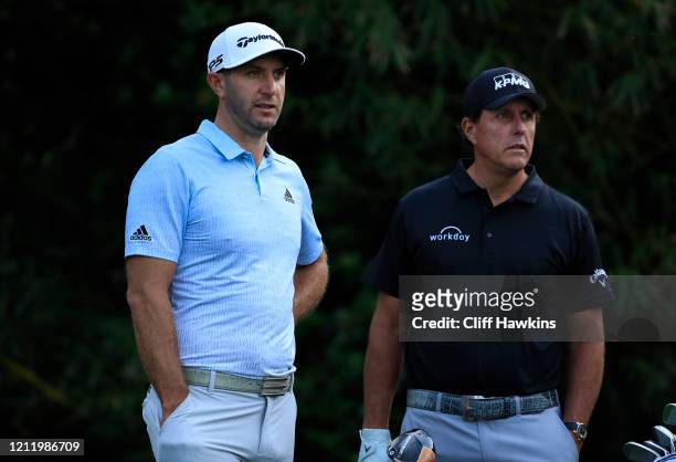 Phil Mickelson of the United States waits on the 11th tee with Dustin Johnson of the United States during the first round of The PLAYERS Championship...
