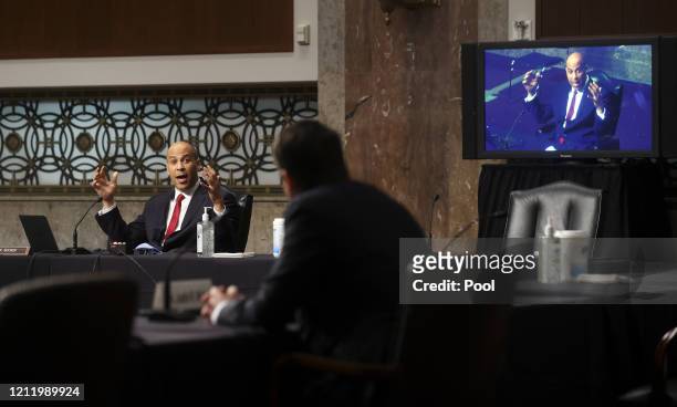 Sen. Cory Booker questions Judge Justin Walker as Booker is broadcast by video link to colleagues attending remotely because of the COVID-19...