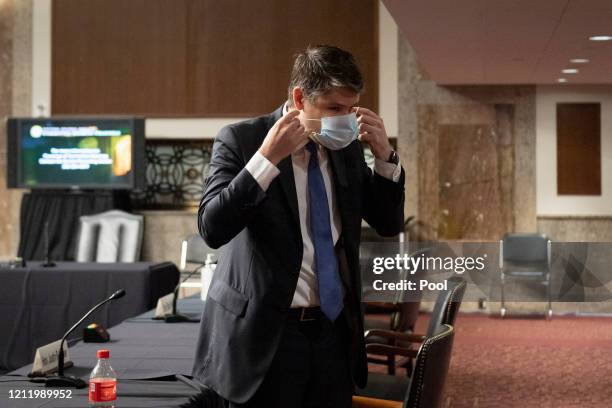 Judge Justin Walker puts on a mask after testifying before a Senate Judiciary Committee hearing on his nomination to be United States Circuit Judge...