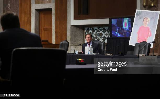 Senator Richard Blumenthal questions Judge Justin Walker while displaying a photo of a young constituent from Ridgefield, Connecticut named Conner...