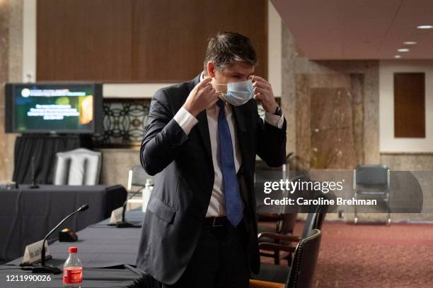 Justin Reed Walker puts on a mask after testifying before a Senate Judiciary Committee hearing on his nomination to be United States Circuit Judge...