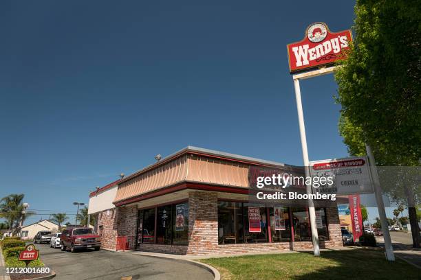 Customers wait at a drive-thru window at a Wendys Co. Restaurant in Richmond, California, U.S., on Wednesday, May 6, 2020. Fast-food chain Wendys Co....