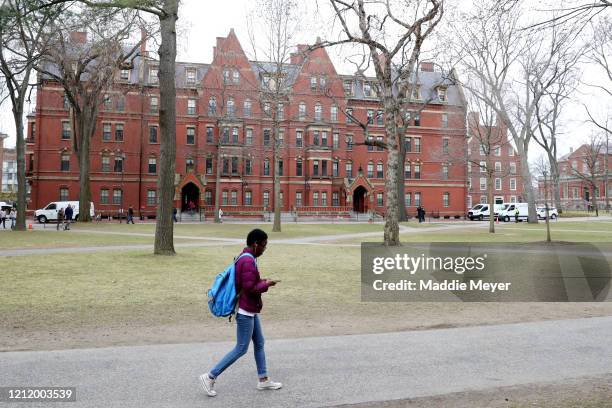 Student walks through Harvard Yard on the campus of Harvard University on March 12, 2020 in Cambridge, Massachusetts. Students have been asked to...