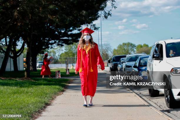 Graduate student arrives to pick up her diploma at Bradley-Bourbonnais Community High School on May 6, 2020 in Bradley, Illinois. - A speech by...