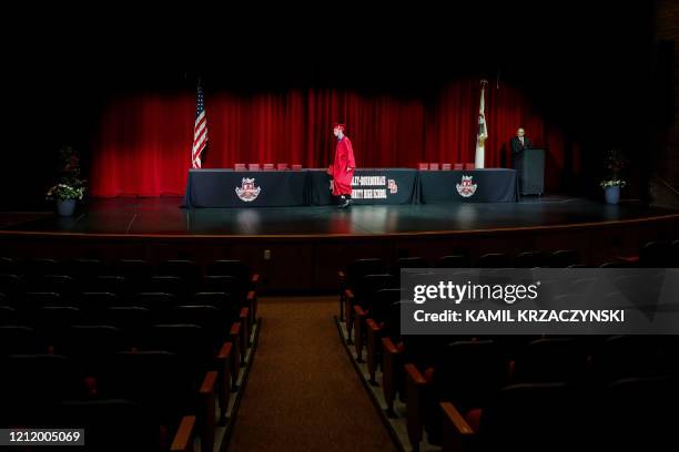 Student picks up his diploma during a graduation ceremony at Bradley-Bourbonnais Community High School on May 06, 2020 in Bradley, Illinois. - A...