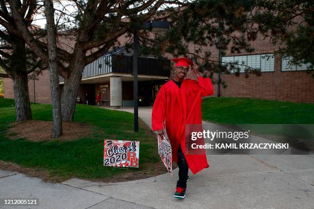 Student Wincent Williams leaves Bradley-Bourbonnais Community High School after picking up his diploma during a graduation ceremony on May 6, 2020 in...