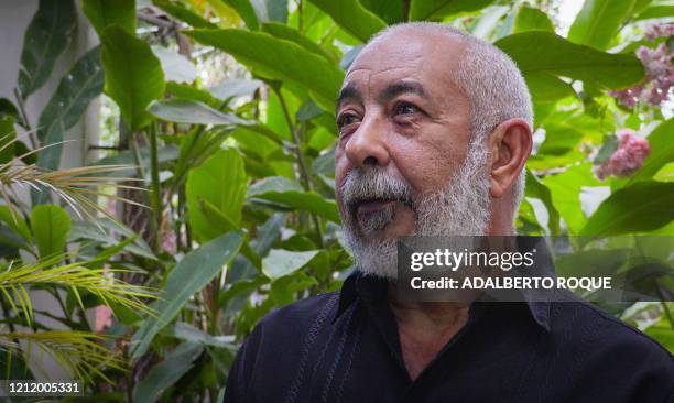 Cuban writer Leonardo Padura poses for a picture during an interview with AFP at his home in Havana, on April 28, 2020. - After defeating all the...