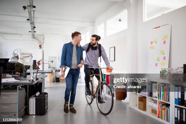 office workers discussing work on the move - return policy stock pictures, royalty-free photos & images