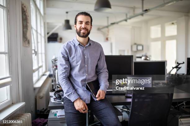 portrait of a young business professional at office - hipster developer stock pictures, royalty-free photos & images