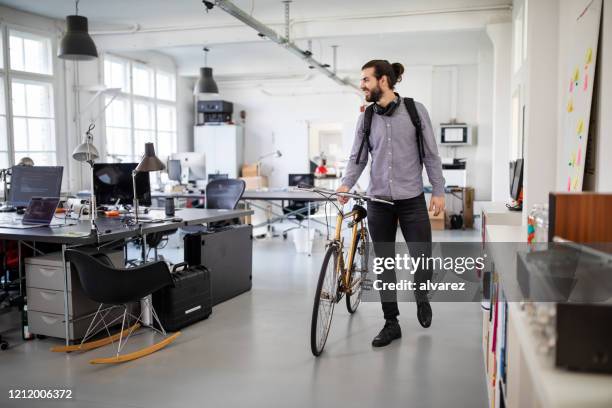 businessman with a bicycle in office - leaving work stock pictures, royalty-free photos & images