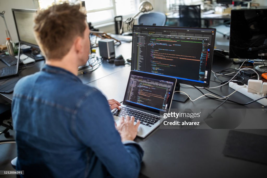 Computer programmer working on new software program