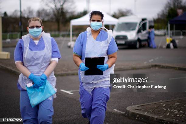 Nurses wait for the next patient at a drive through Coronavirus testing site in a car park on March 12, 2020 in Wolverhampton, England. The National...