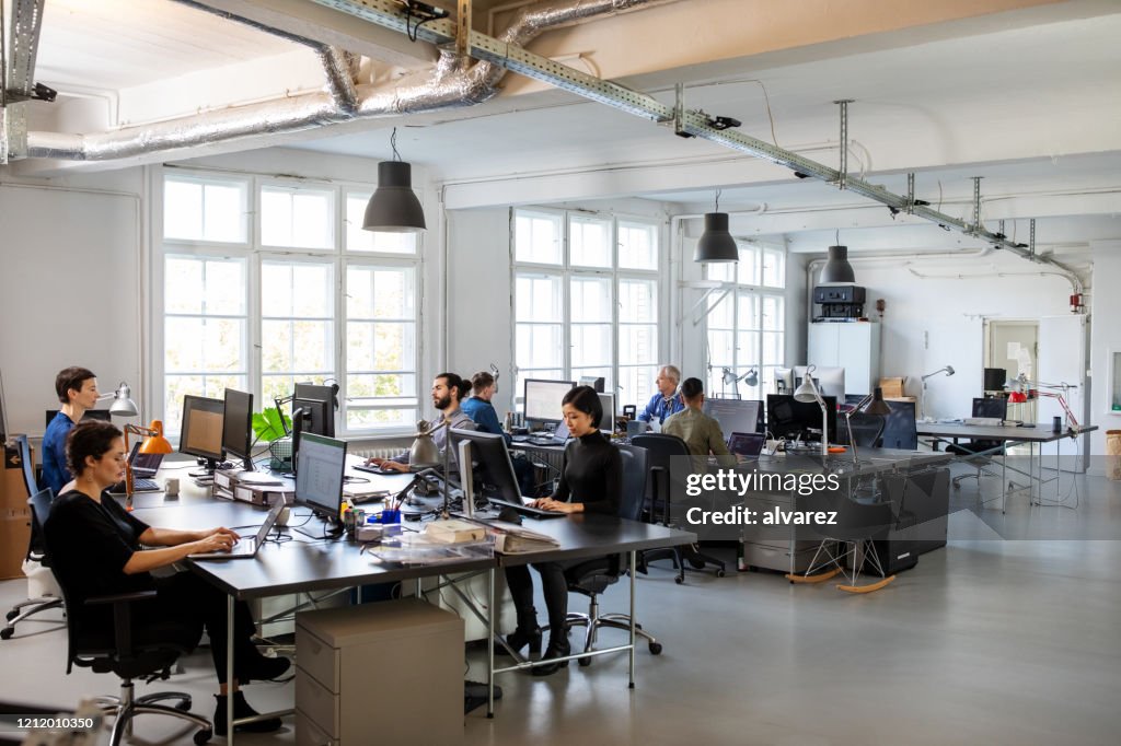 Affollato ufficio moderno a pianta aperta con personale