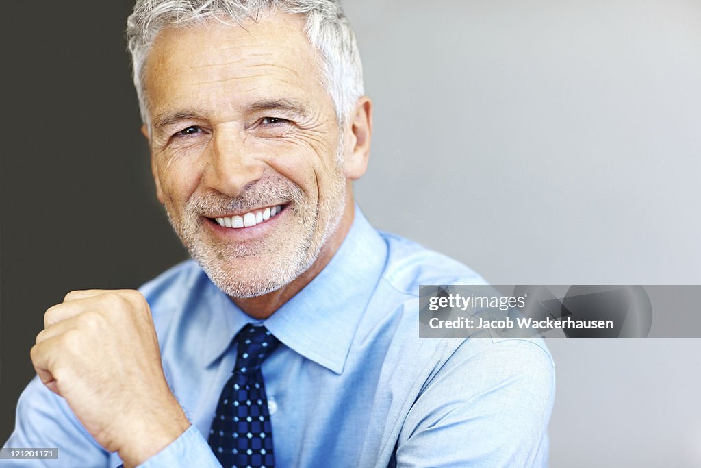 Successful mature business man smiling - Copyspace