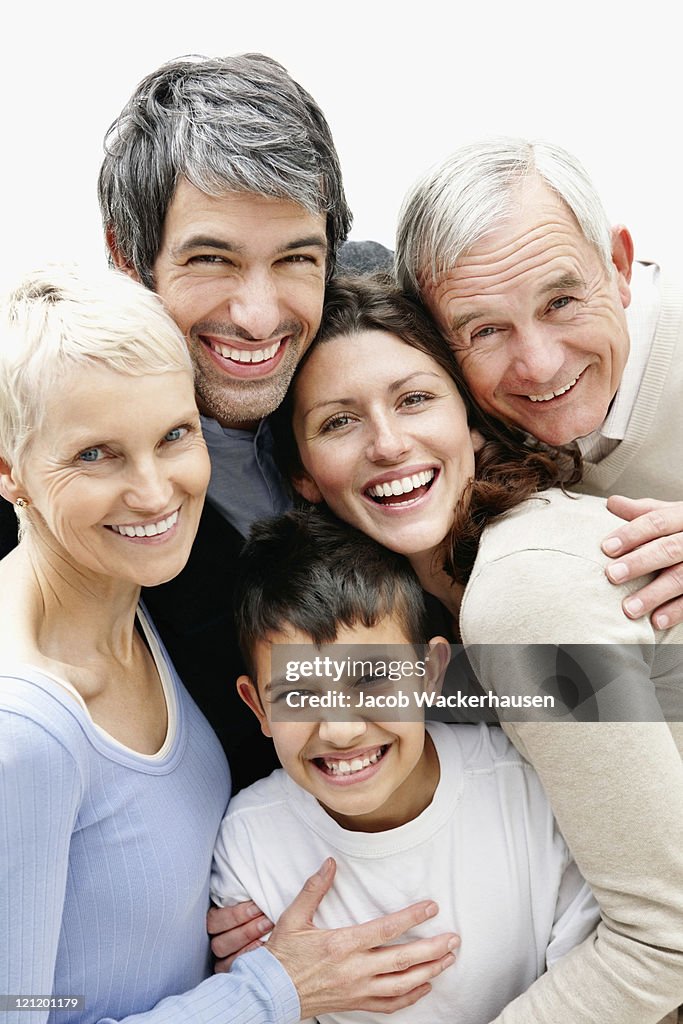 Cheerful loving multi generational family smiling together