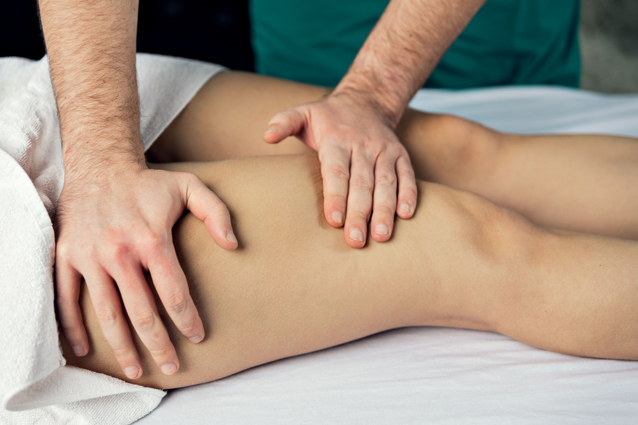Lymphatic drainage massage of the hips. Man's hands. Lymphatic drainage massage of the hips. Man's hands.
