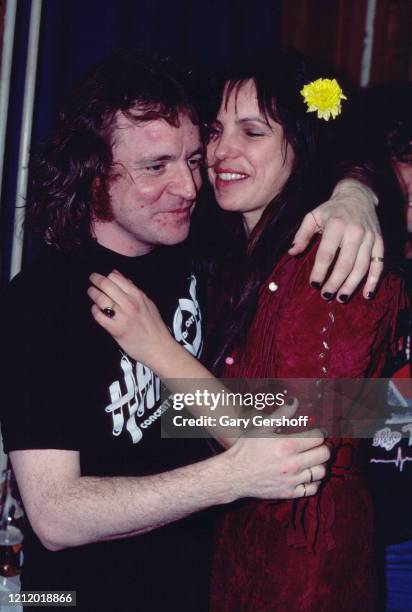 Scottish Rock, Jazz, and Blues musician Jack Bruce embraces an unidentified woman backstage at the Palladium, New York, New York, December 13, 1980....