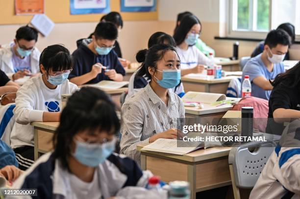Students wearing face masks are seen in their classroom during a government organised media tour at Shanghai High School after it reopened in...
