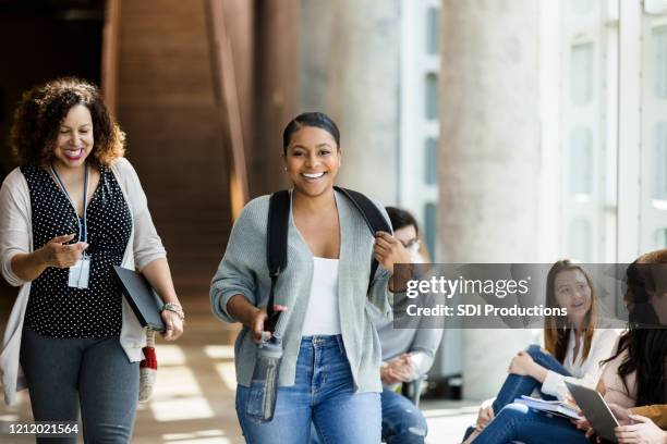 female college student walking to class - community college campus stock pictures, royalty-free photos & images