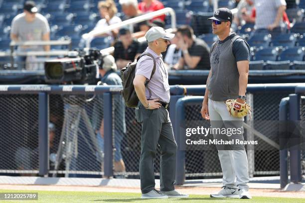 New York Yankees general manager Brian Cashman talks with manager Aaron Boone prior to a Grapefruit League spring training game against the...