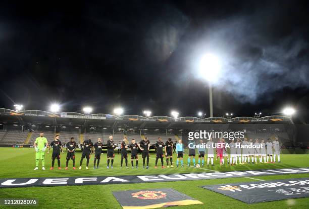 In this handout image provided by UEFA, The Manchester United and LASK teams line up in a empty stadium prior to the UEFA Europa League round of 16...
